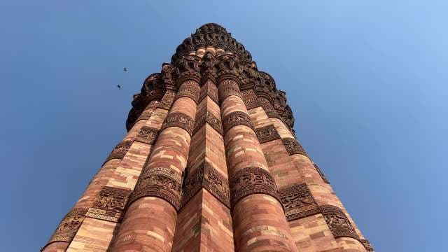Majestic Qutb Minar Tower Against Clear Blue Sky
