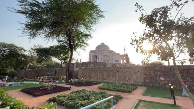Majestic Tomb in Delhi's Lush Heritage Garden at Sunset