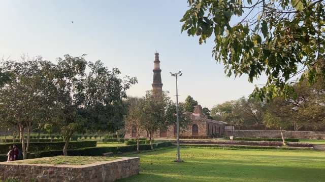 Majestic Qutub Minar in Lush Gardens, Delhi Landmark View