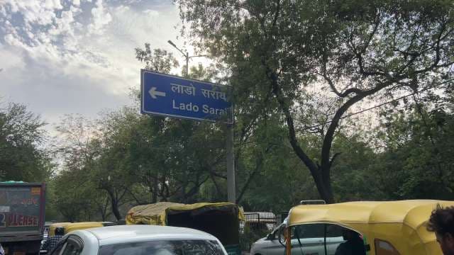 Traffic Near Lado Sarai Sign in New Delhi