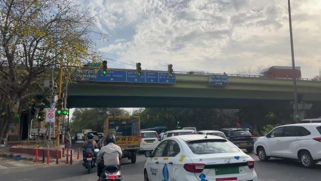 Busy Delhi Road Intersection With Traffic and Overpass Signs