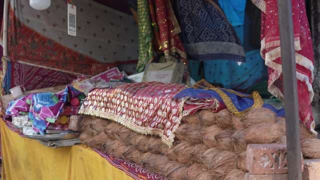 Traditional Indian Market Stall With Colorful Fabrics and Coconuts