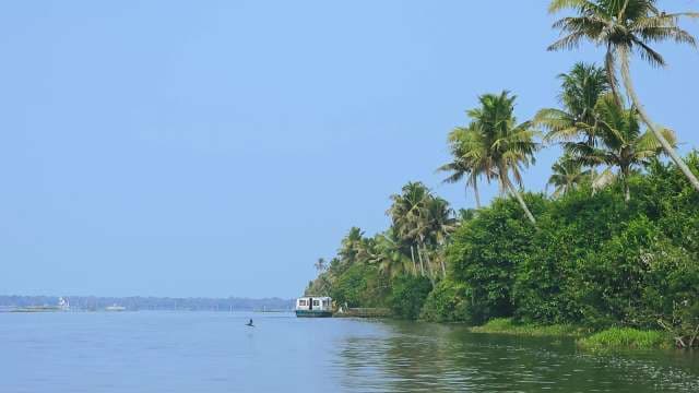 Scenic Kerala Backwaters With Houseboat and Palm Trees