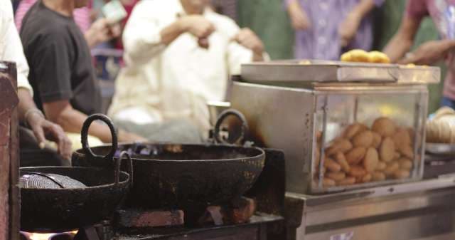 Street Food Vendor Frying Snacks in Sarafa Market, Indore, India