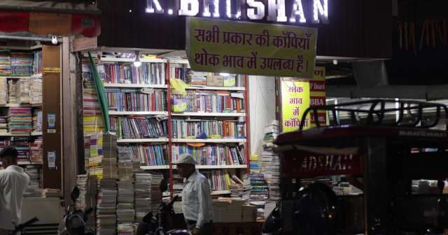 Busy Indian Bookstore at Night With Stacked Books Indore