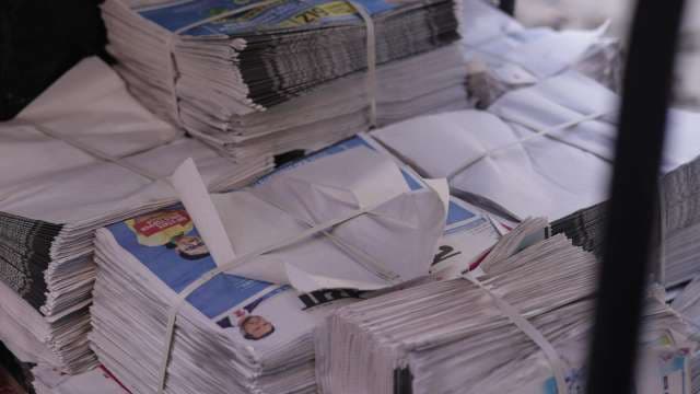 Stacks of Fresh Newspapers Ready for Distribution