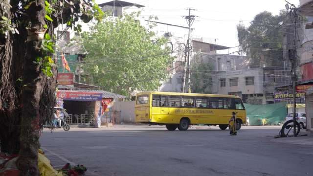Yellow School Bus in Busy Indian City Street Scene
