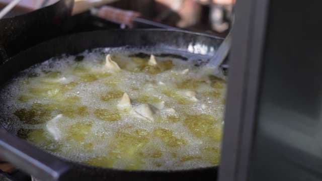 Street Vendor Deep Fries Fresh Samosas in Hot Oil