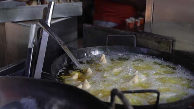 Street Vendor Frying Fresh Samosas in Hot Oil