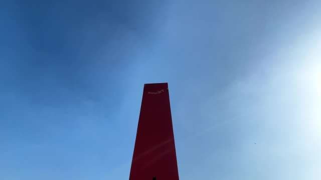 Striking Red Obelisk Against Clear Blue Sky