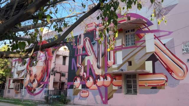 Vibrant Urban Mural Transforms Residential Building Exterior