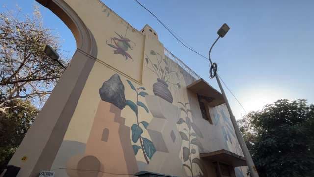 Urban Wall Mural of Plants and Geometric Shapes in Daylight