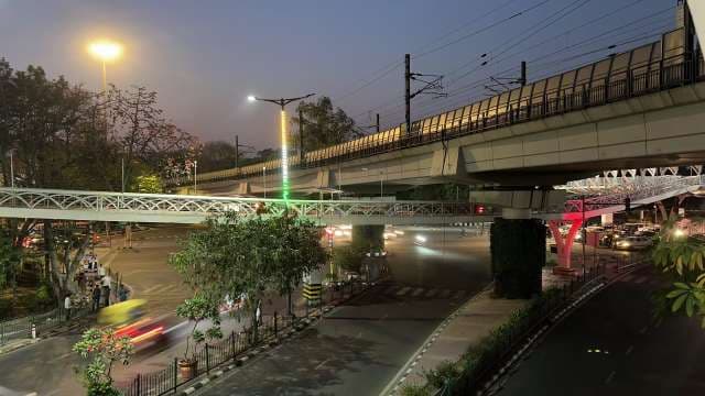 Night Traffic Flow Under Metro Bridge in Cityscape