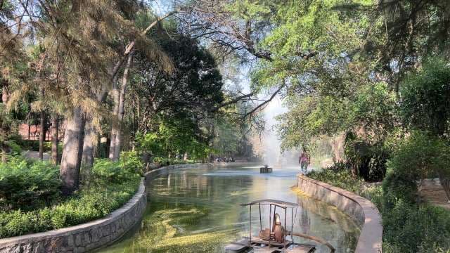 Scenic Urban Park Pond With Fountain and Walkway