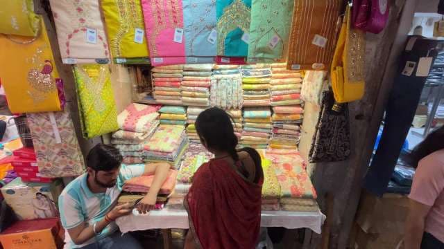 Colorful Indian Fabric Market Stall With Shoppers