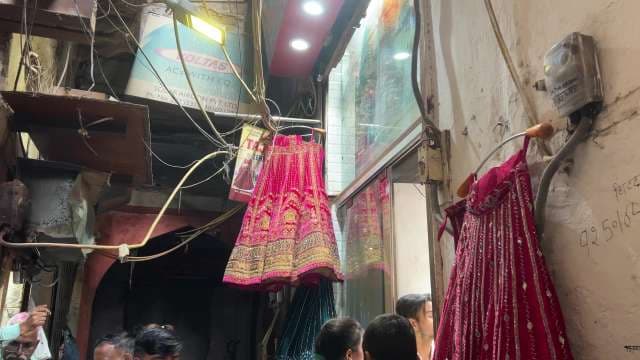 Traditional Bridal Lehengas Displayed in Bustling Indian Market