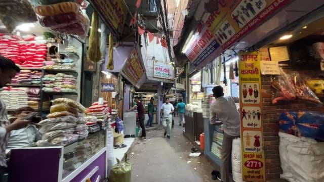 Bustling Indian Alleyway Market With Colorful Textile Shops