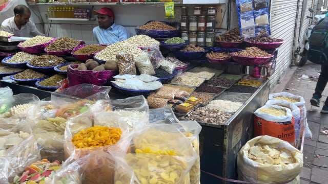 Vibrant Indian Spice Market Stall with Fresh Herbs and Nuts