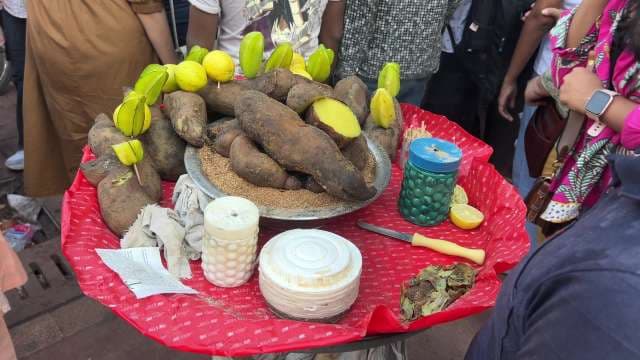Traditional Indian Street Food Vendor Selling Steamed Yam and Fruits