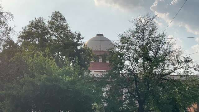 Supreme Court of India Dome Behind Lush Green Trees
