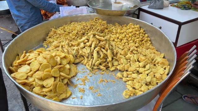 Street Vendor Prepares Assorted Indian Pakoras and Fritters