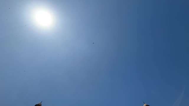 Bright Sun and Blue Sky Above City Spires