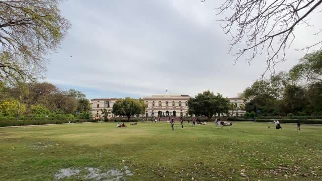 People Enjoying a Green Lawn at Historic City Park