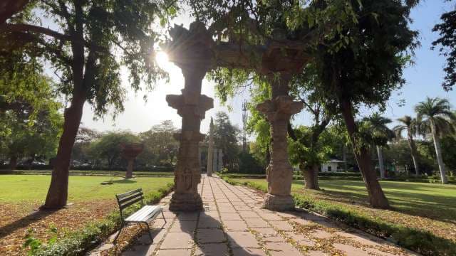 Ancient Stone Archway in Serene City Park Setting