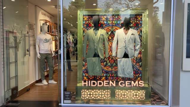 Hidden Gems: Stylish Men's Suits Display in Storefront
