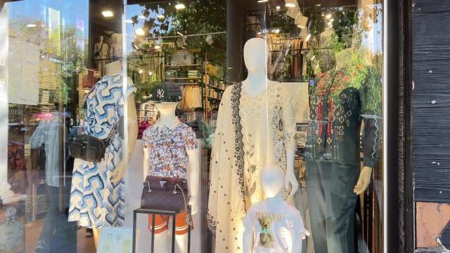 Trendy Boutique Fashion Window Display Showcasing Seasonal Styles