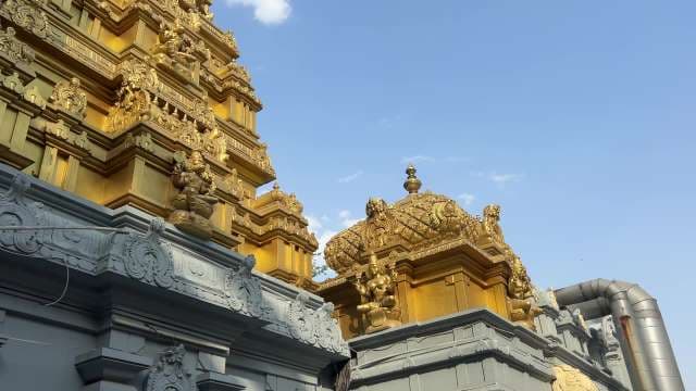 Stunning Golden Hindu Temple Tower Shines Under Blue Sky