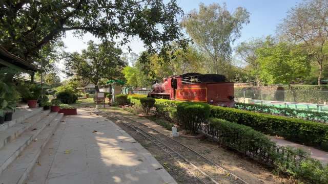 Miniature Train Exhibit in Lush Garden Setting