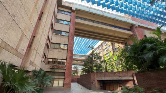 Modern Architectural Courtyard With Blue Geometric Overhead Canopy