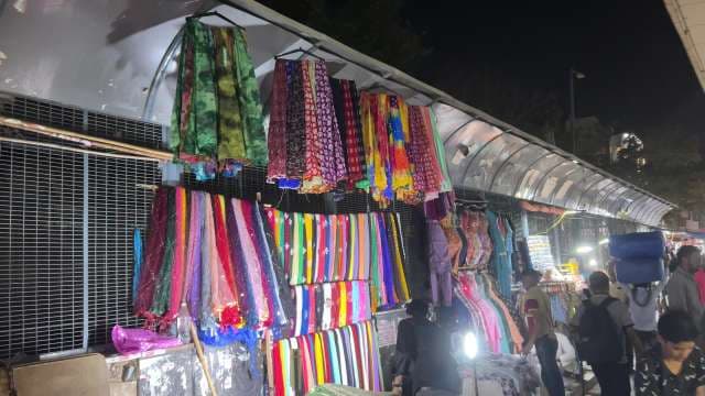 Vibrant Night Market With Colorful Traditional Fabrics