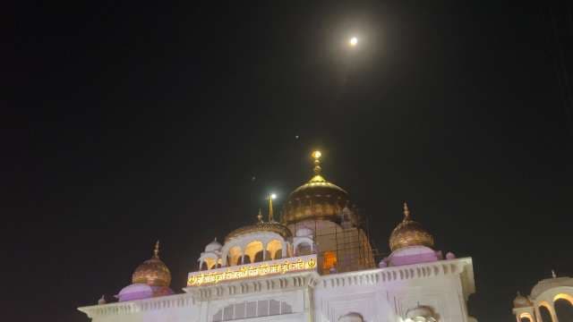 Golden Temple Illuminated at Night Under Full Moon