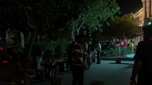 Nightlife Gathering at Urban Park Under City Lights