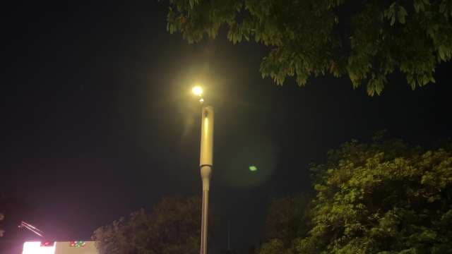 Bright Street Lamp Illuminates Nighttime Cityscape