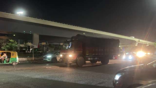 Busy Night Traffic Near City Flyover With Trucks and Rickshaws