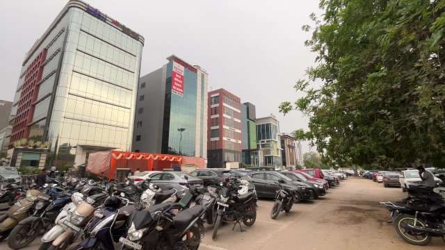 Modern Office Complexes and Busy Parking Lot in Gurugram