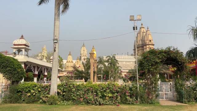 Majestic Jain Temple Complex in Lush Garden Setting