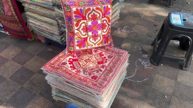 Vibrant Hand-Embroidered Cushion Covers on Street Market Display