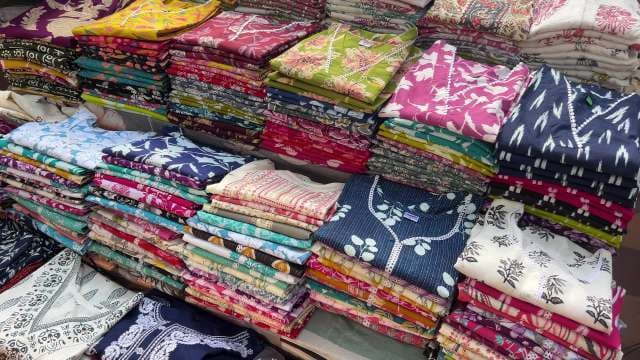 Vibrant Display of Cotton Kurtas at Local Indian Market