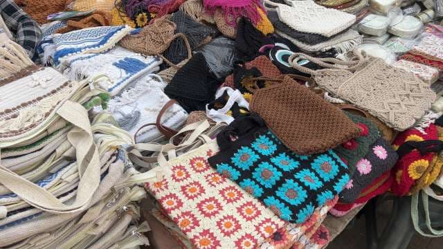 Colorful Handmade Crochet and Woven Bags Displayed at Market