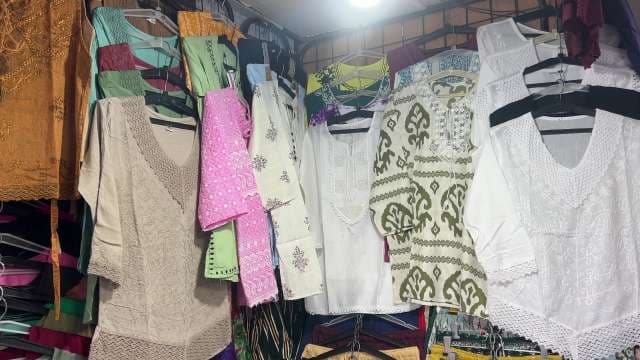 Colorful Embroidered Kurtis Displayed at Traditional Clothing Market