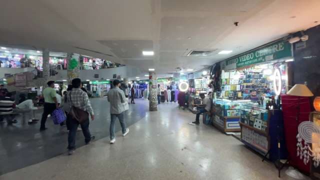 Bustling Indoor Market With Electronics and Clothing Shops