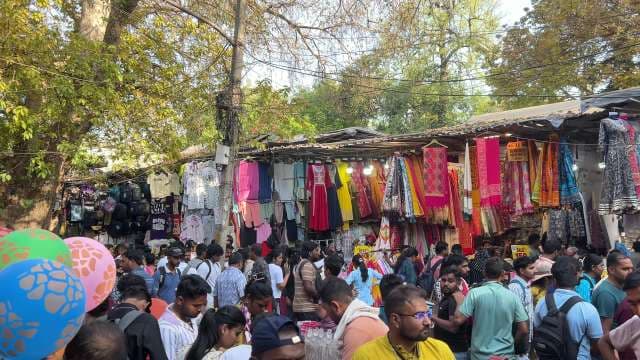 Bustling Indian Street Market With Colorful Clothing Stalls