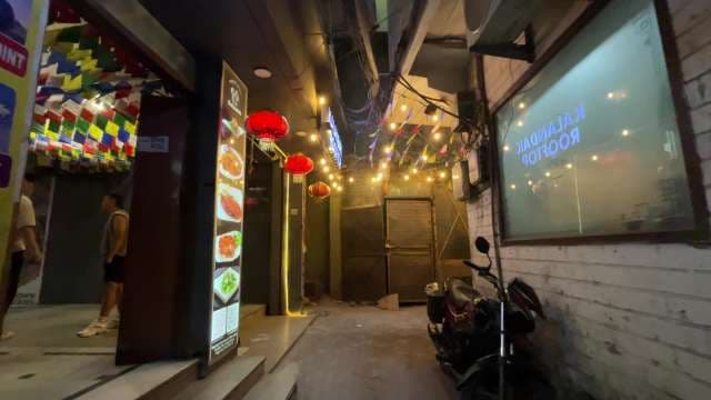 Vibrant Urban Alleyway With Lanterns and Restaurant Signs at Night