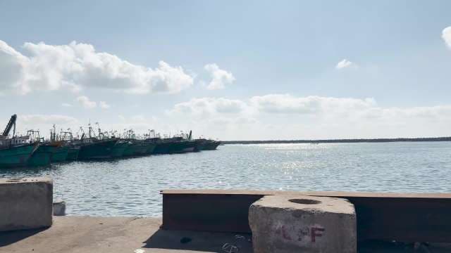 Fishing Boats Docked Under Blue Sky at Harbor