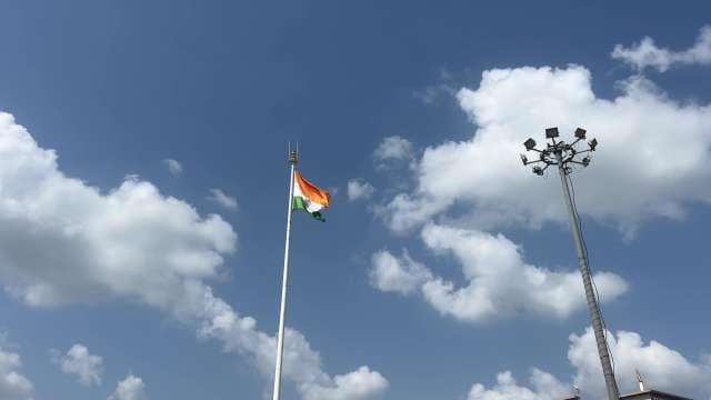 Indian Flag Waving Proudly Against Blue Sky