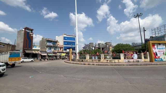 Bustling City Roundabout With Statue and Urban Surroundings